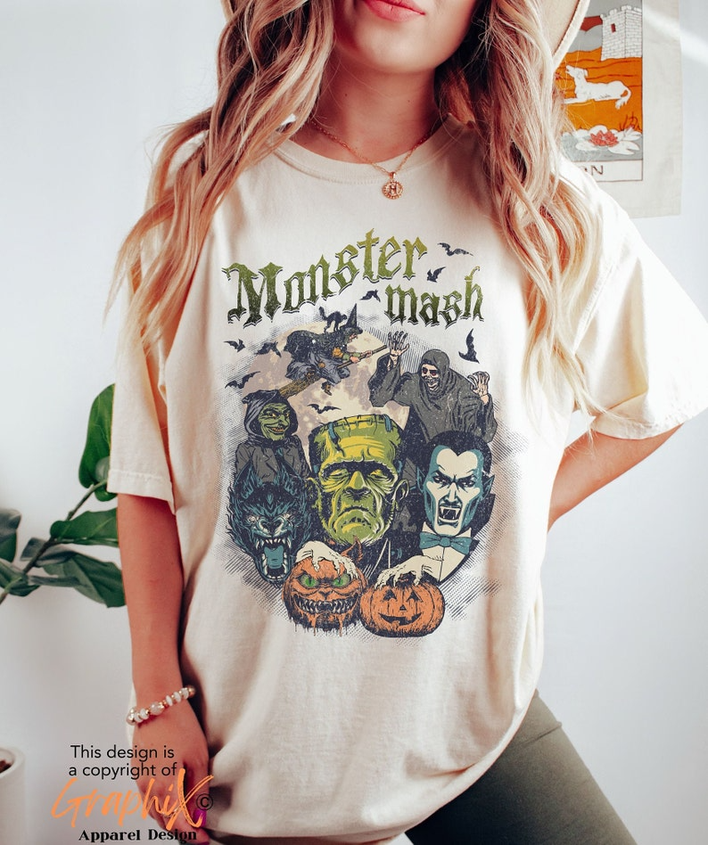 a woman wearing a white shirt with a picture of monsters on it