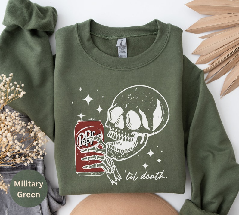 a green sweatshirt with a skull and a can of bud of death on it