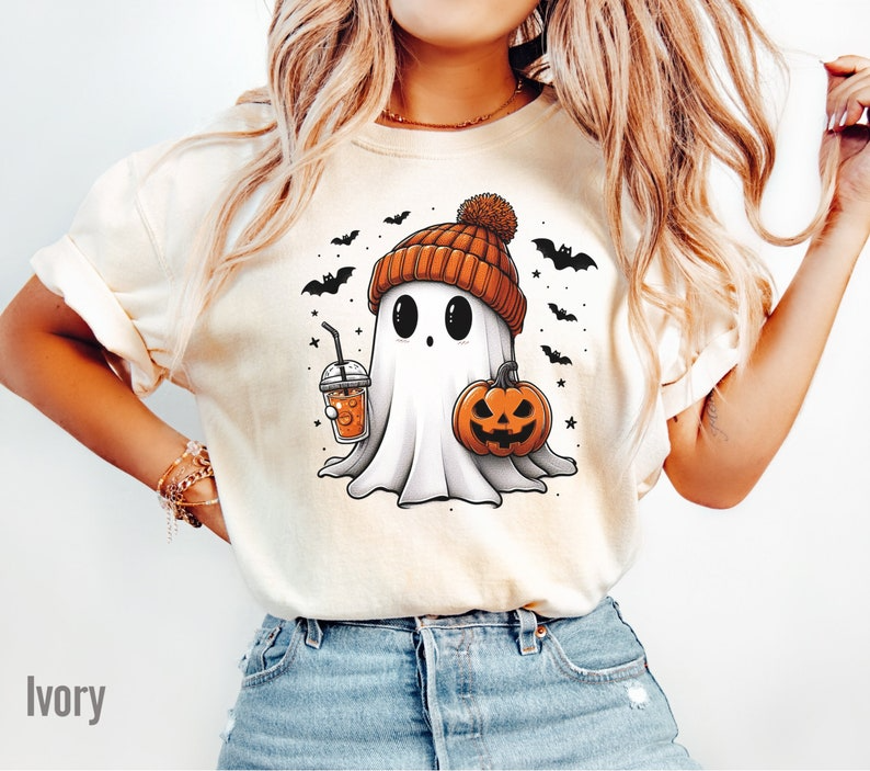 a woman wearing a halloween t - shirt with a ghost on it