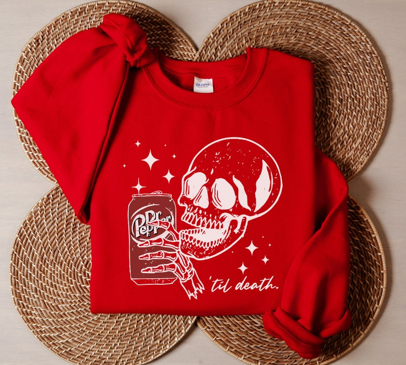 a red shirt with a skull and a can of beer