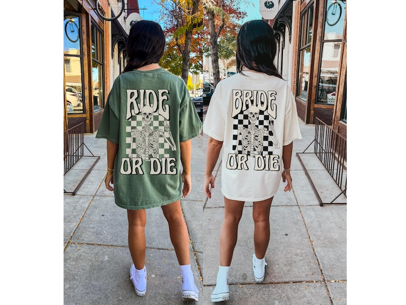 two women walking down a sidewalk holding hands