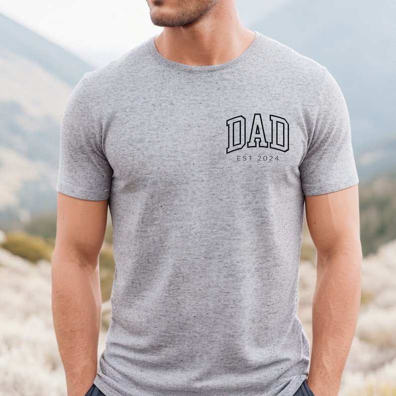 a man wearing a grey shirt with a dad on it