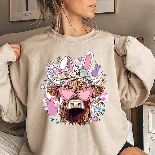 a woman wearing a sweatshirt with a picture of a cow on it