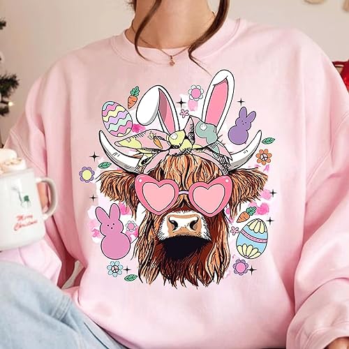 a woman wearing a pink sweatshirt with a cow wearing glasses