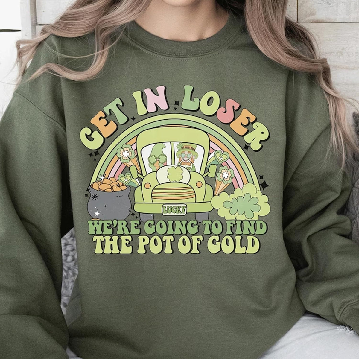 a woman wearing a green sweatshirt that says get in loose here going to find the