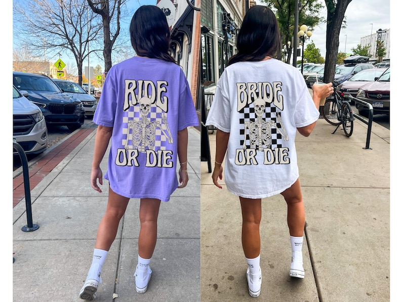 two women walking down a sidewalk wearing matching shirts