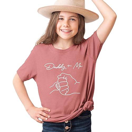 a little girl wearing a hat and a t - shirt