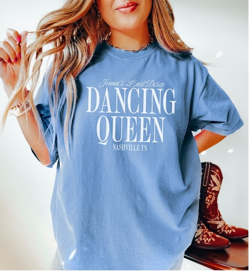 a woman wearing a blue shirt with dancing queen on it