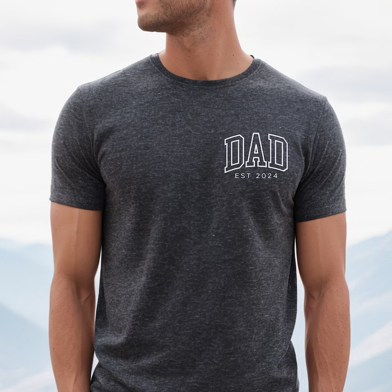 a man wearing a hat and a t - shirt with the word dad on it