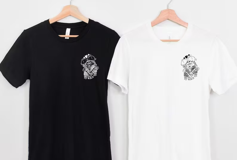 two black and white tshirts hanging on a wall