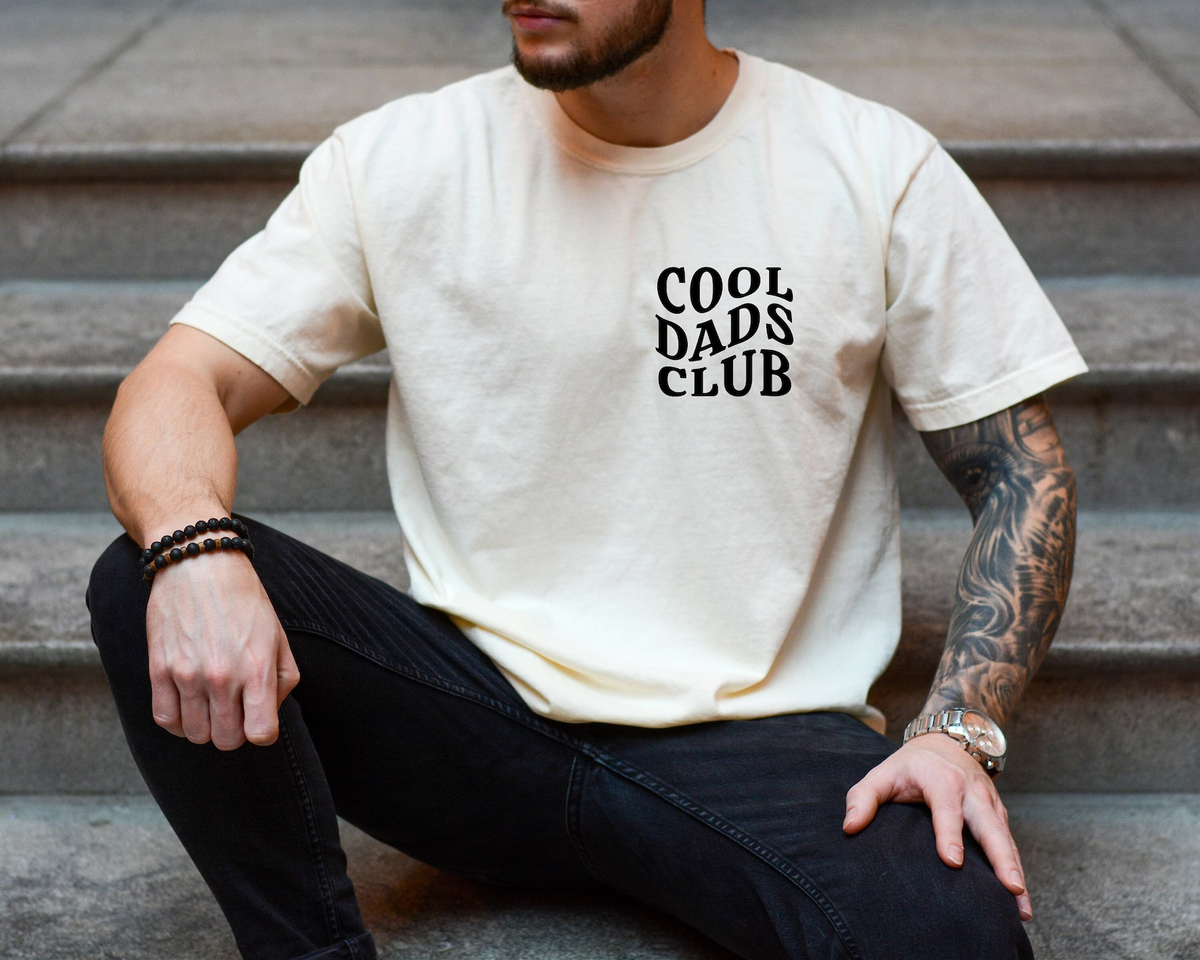 a man sitting on the steps wearing a cool days club t - shirt