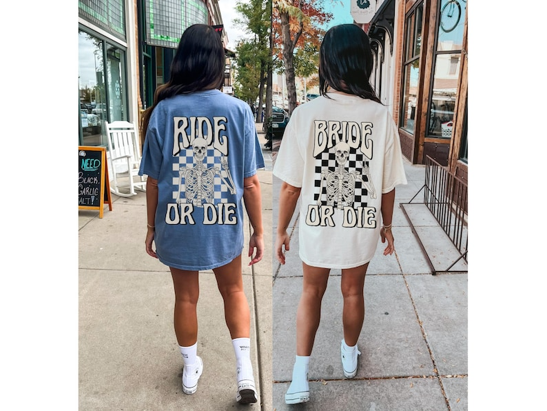 two women walking down a sidewalk wearing matching shirts