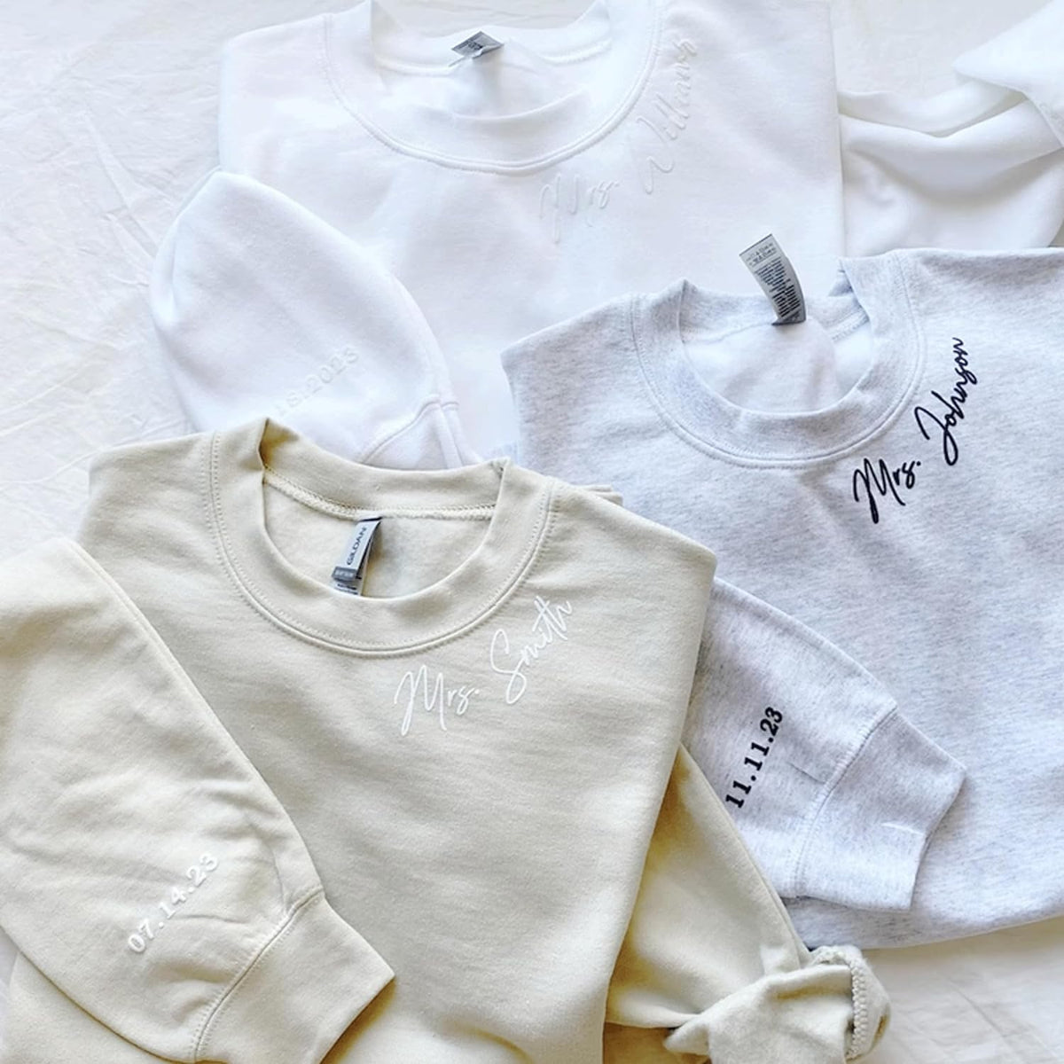 a group of white shirts sitting on top of a bed