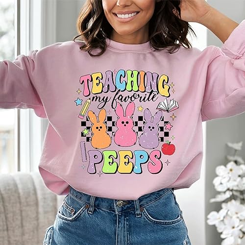 a woman wearing a pink teaching my favorite pees sweatshirt