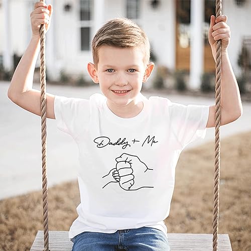 a young boy is sitting on a swing